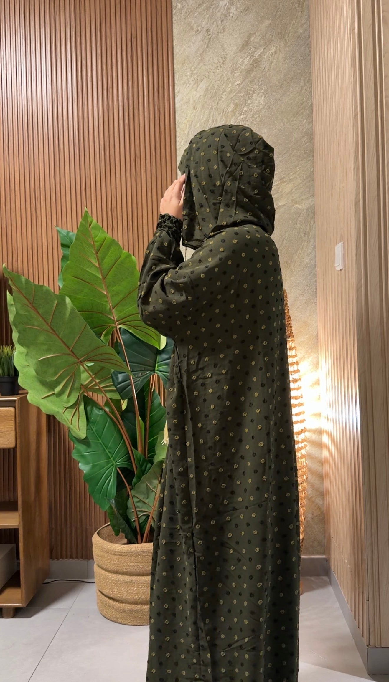 Green burqa with black dots