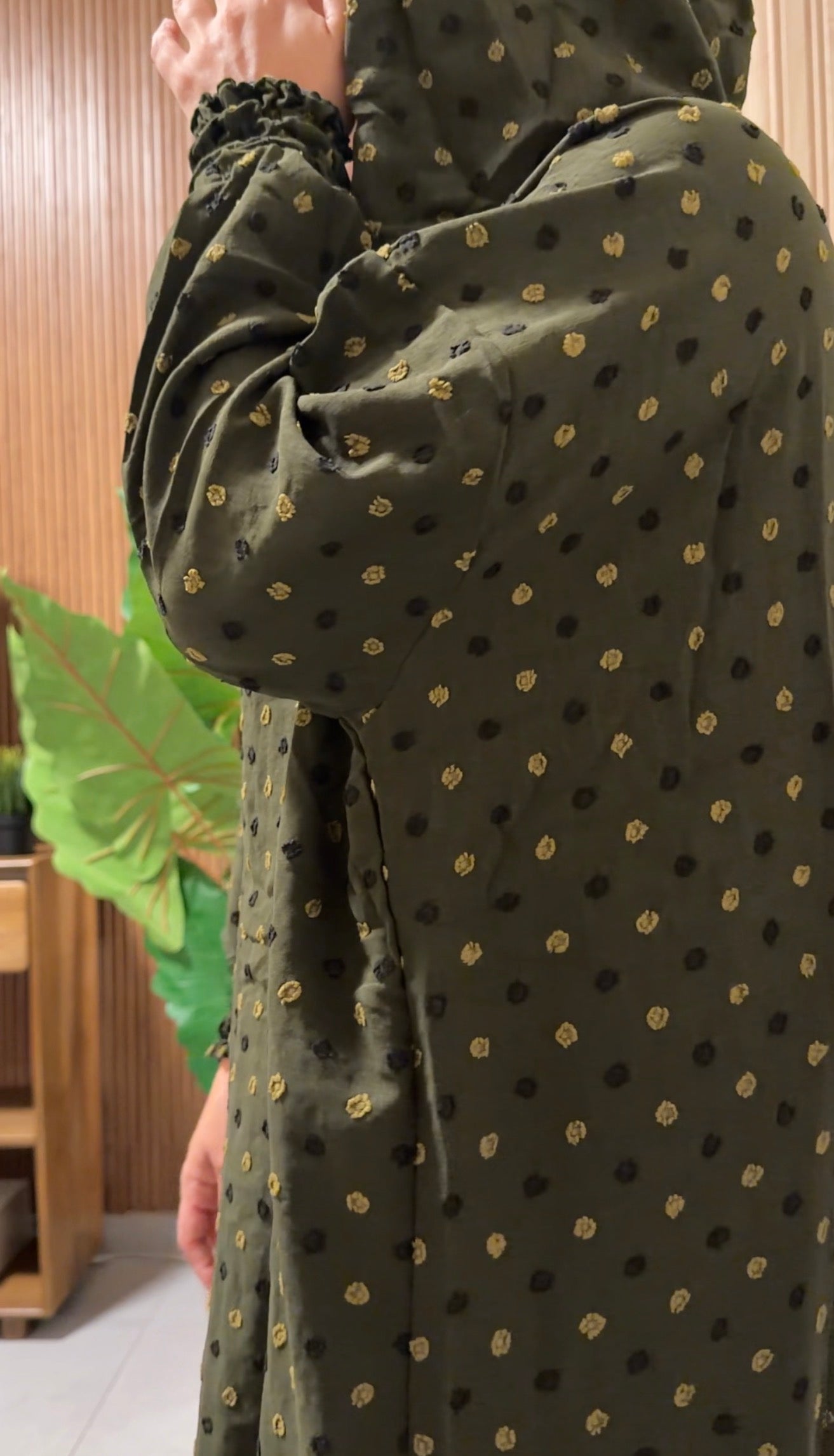 Green burqa with black dots