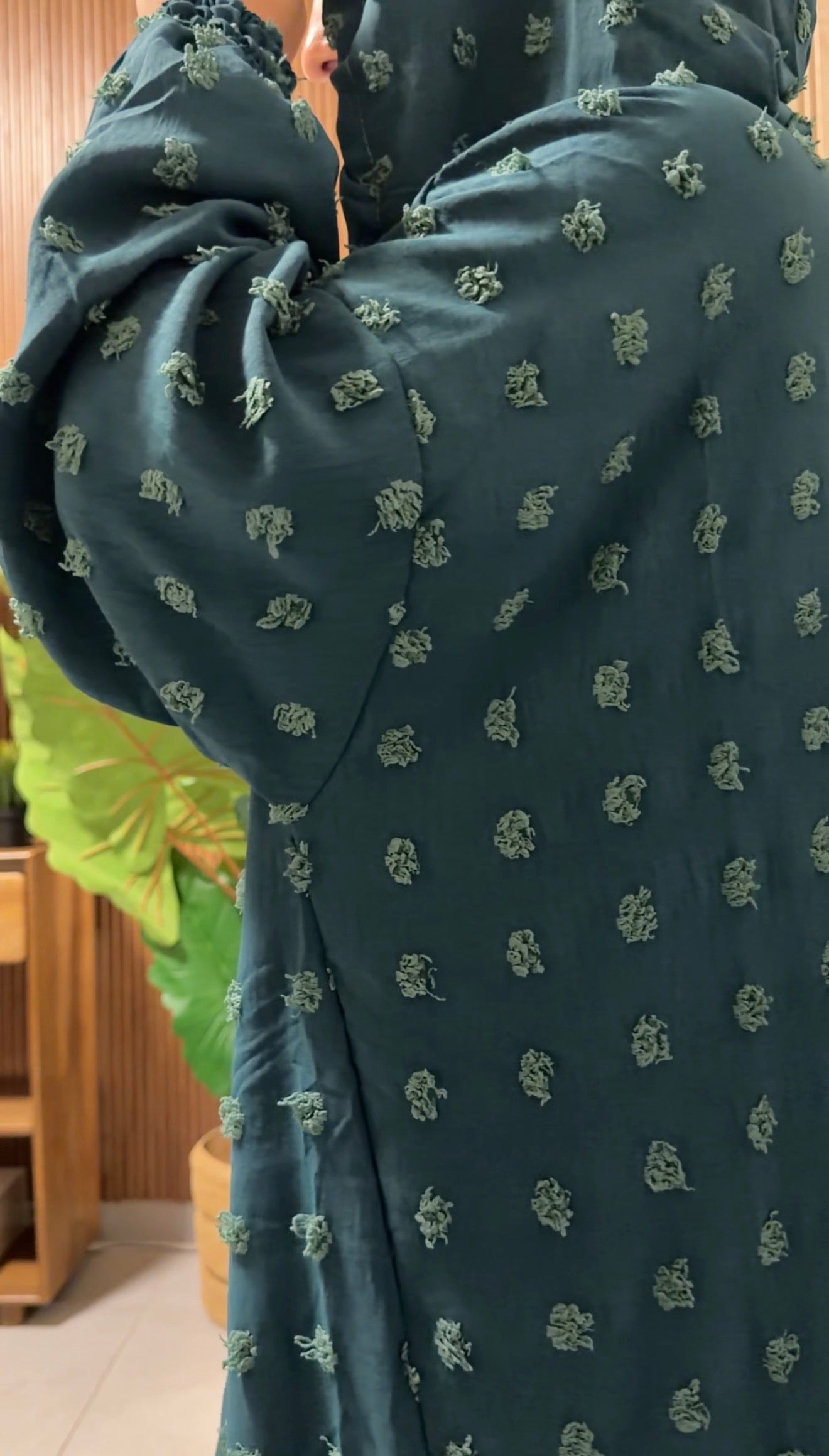Dark green burqa with big dots.