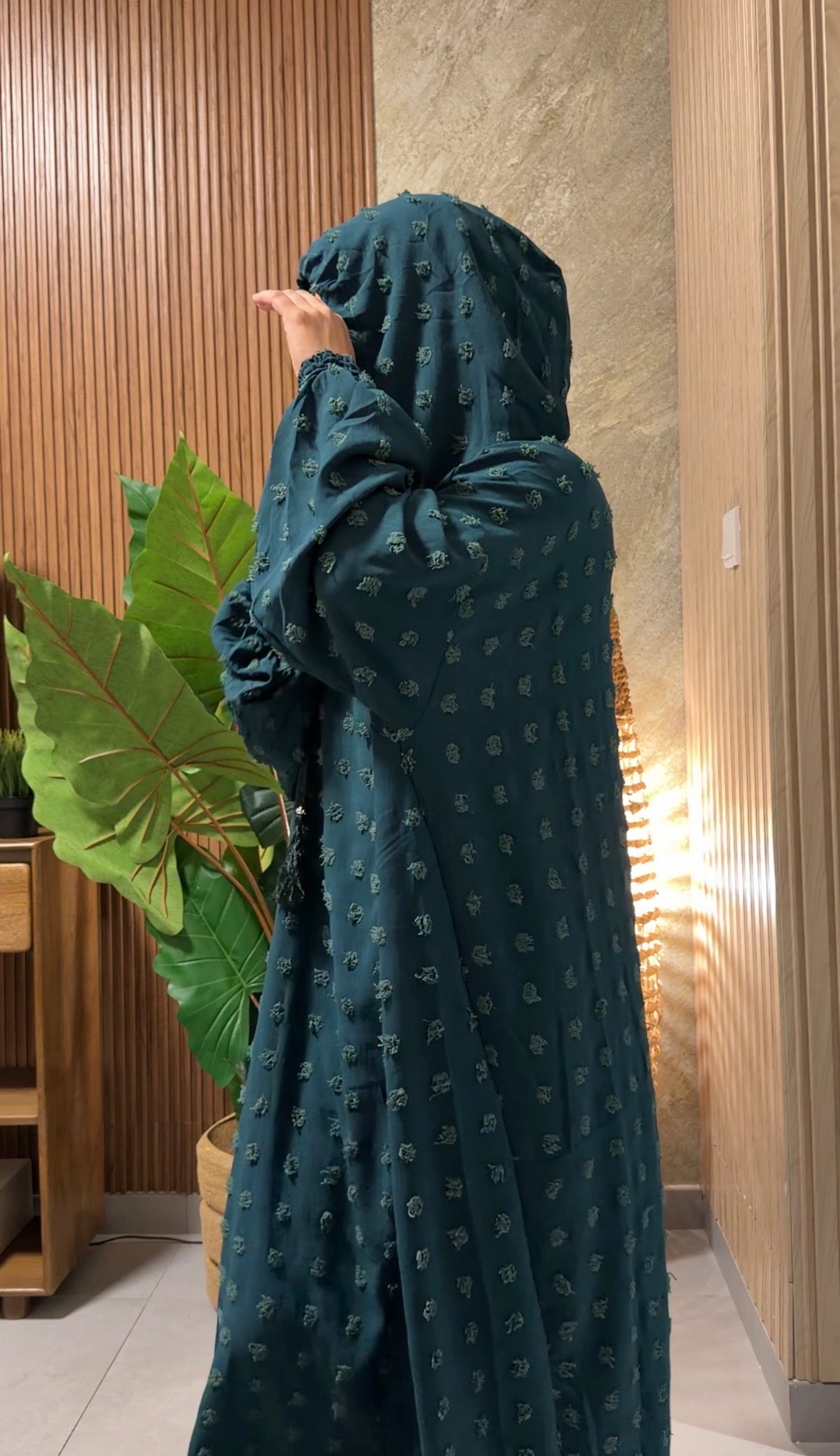 Dark green burqa with big dots.